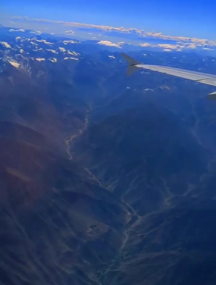 Snow peaks seen from a plane window