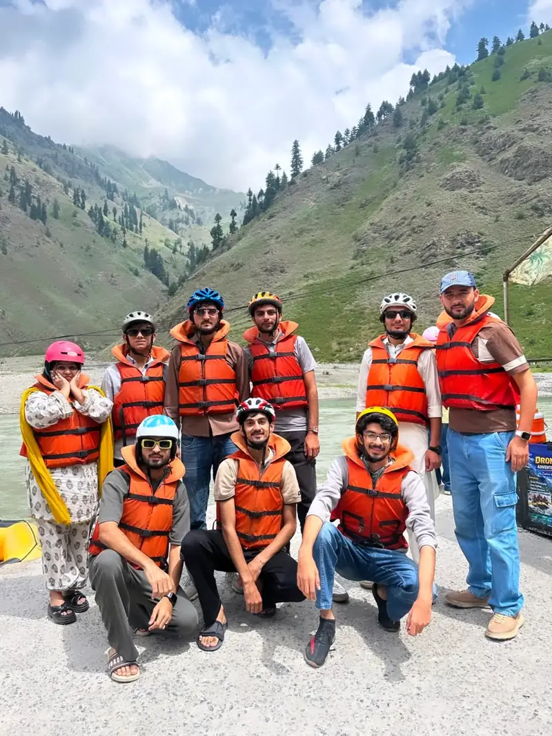 A weekend group in life jackets by a river