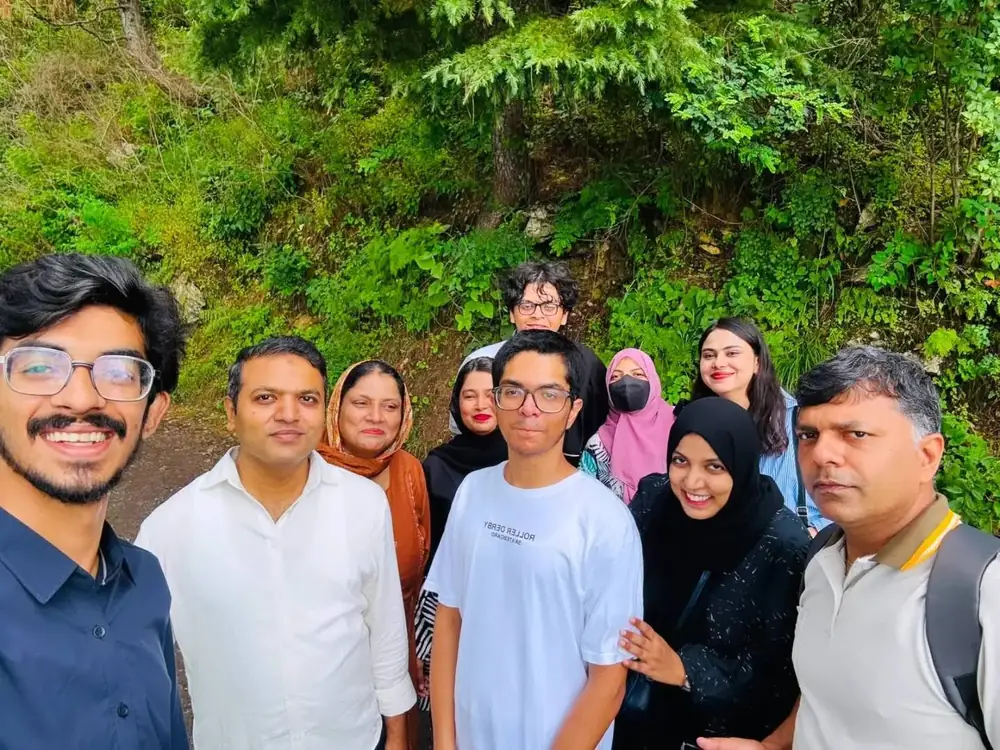 Travellers smiling on a hilltop