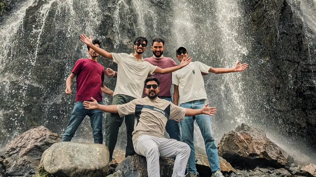 A tour group at a waterfall